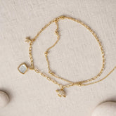 gold charm chain bracelet with star shell charms