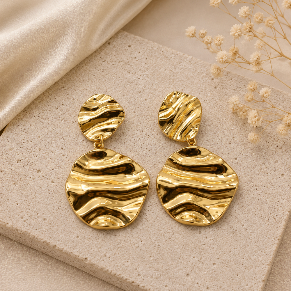 Gold sculptural statement earrings for women with wavy textured design