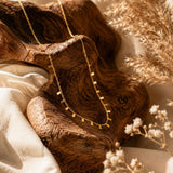 Gold-tone charm necklace with geometric dangling accents for women