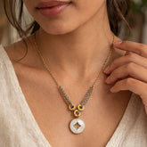 layered gold chain necklace with round white inlay pendant
