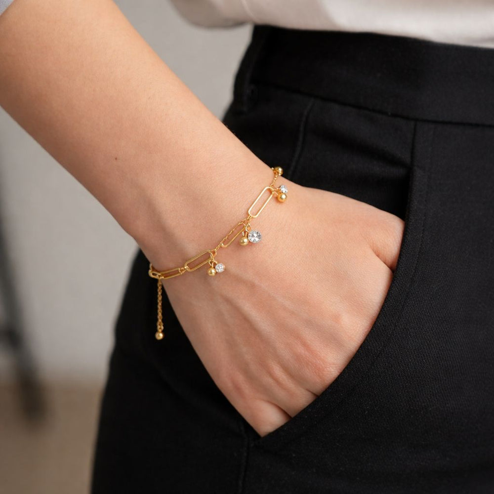 Delicate gold charm bracelet with crystal stones and adjustable chain