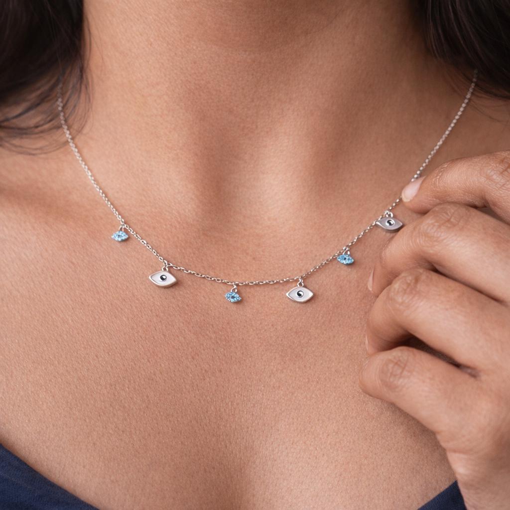 evil eye charm necklace with blue crystal details minimal protective jewellery
