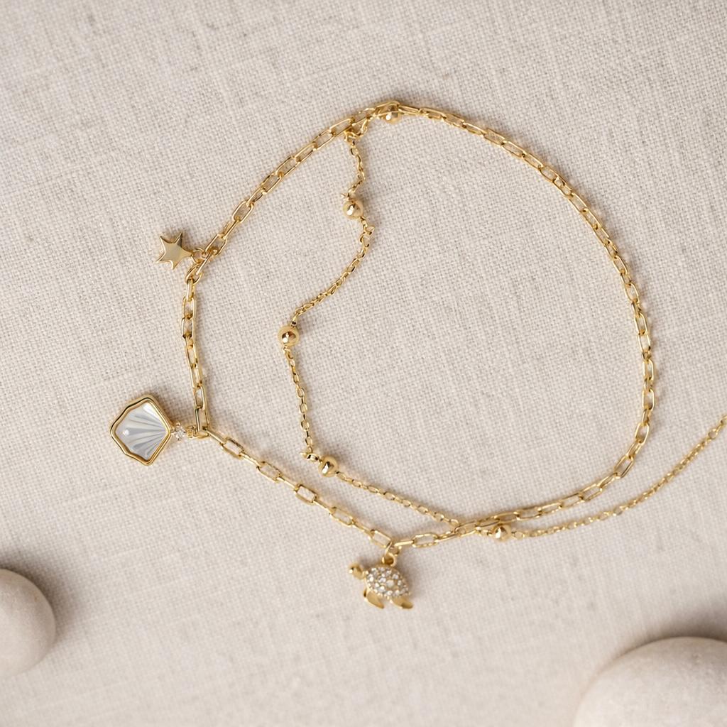 gold charm chain bracelet with star shell charms